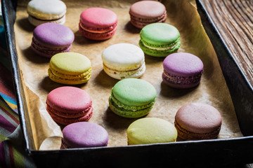 Sweet macaroons on baking tray