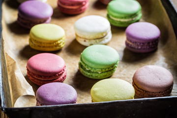 Tasty macaroons on baking tray