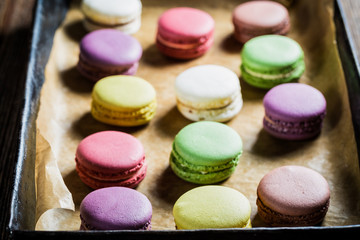 Delicious macaroons on baking tray