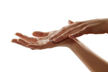 Close-up of female hands apllying hand cream