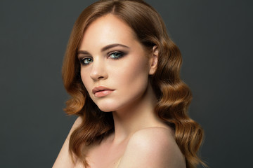 Naklejka premium Beauty Woman Portrait. Healthy Long Red Hair and perfect holiday