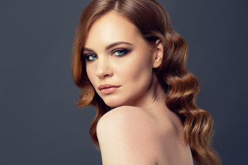 Fototapeta premium Beauty Woman Portrait. Healthy Long Red Hair and perfect holiday