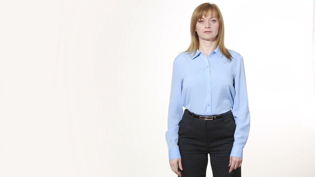 insincere gesture. mouth is closed with one hand. girl in pants and blous.  Isolated on white background. body language. women gestures. nonverbal cues