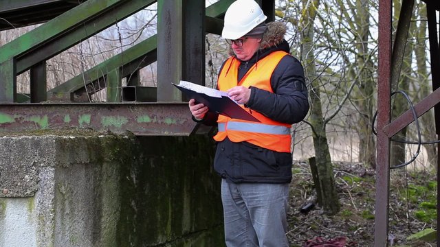 Engineer with documentation checking territory
