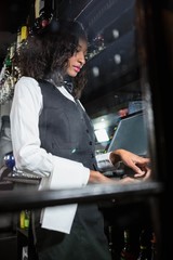 Barmaid preparing a bill in bar