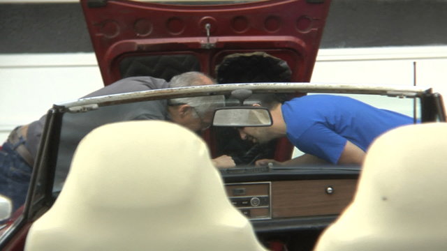 Father And Son Fixing A Car