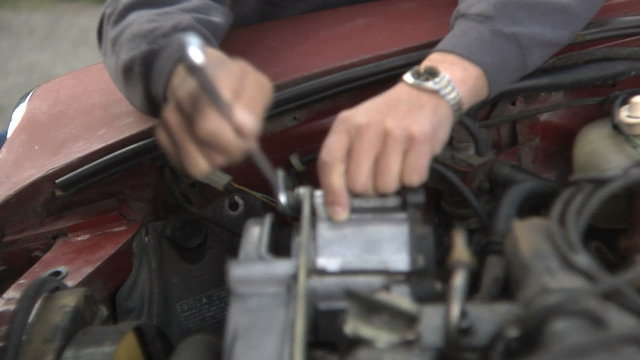 Senior man fixing car