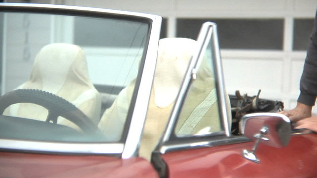 Portrait of senior man in classic car