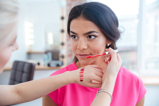 Makeup Artist Testing Lip Gloss And Choosing Color For Woman