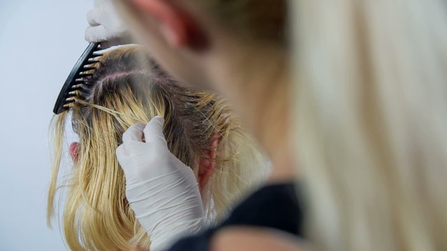 Hair styler preparing the head for colouring 