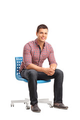 Young cheerful man sitting on a chair