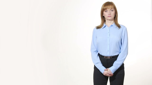 wringing his fingers. uncertainty. girl in pants and blous.  Isolated on white background. body language. women gestures. nonverbal cues