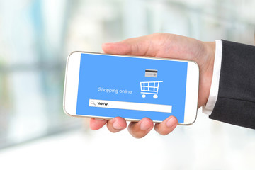 On line shopping on smart phone screen over blur background