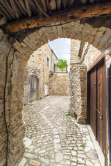 Fototapeta na wymiar Fisheye view on vanishing medieval narrow pavement street passage with stonemasonry building. Pano Lefkara, Cyprus. 