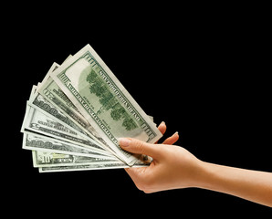 Hand holding money isolated on black background