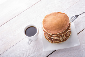 Tasty pancakes with coffee cup