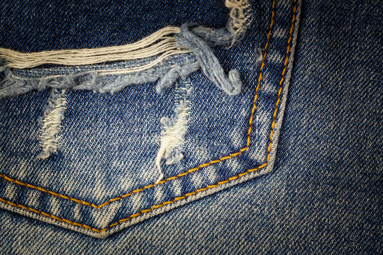 Old pocket blue jeans dirty at torn for background.