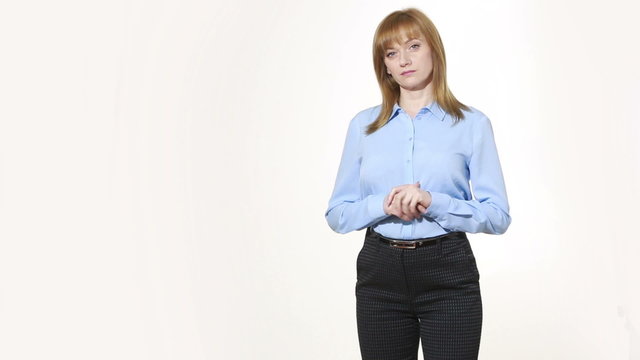wringing his fingers. uncertainty. girl in pants and blous.  Isolated on white background. body language. women gestures. nonverbal cues