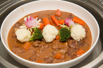 Beef stew in a white crock pot