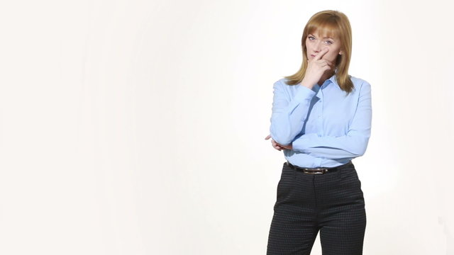 insincere gesture. mouth is closed with one hand. girl in pants and blous.  Isolated on white background. body language. women gestures. nonverbal cues