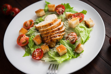Caesar salad with chicken and tomato