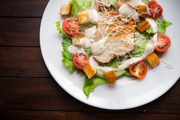 Caesar salad with chicken and tomato