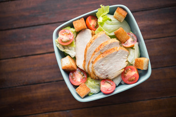 Caesar salad with chicken and tomato