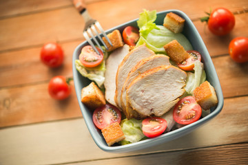 Caesar salad with chicken and tomato