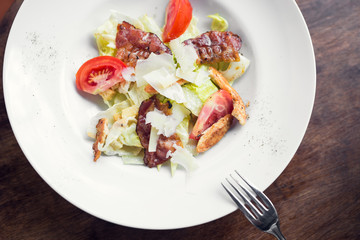Caesar salad with chicken and tomato