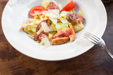 Obraz na płótnie Canvas Caesar salad with chicken and tomato
