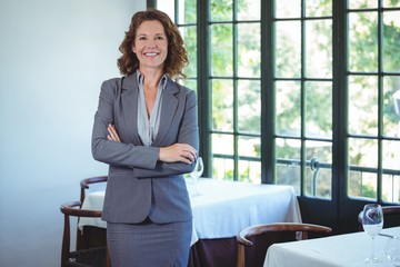 Smiling businesswoman posing with crossed arms