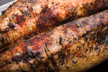 Fish on the grill with lemon on white plate