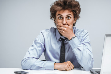 Businessman shocked what happened, looking at camera / modern office man at working place, depression and crisis concept