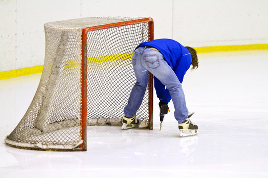 toolmaker work near the ice hockey net