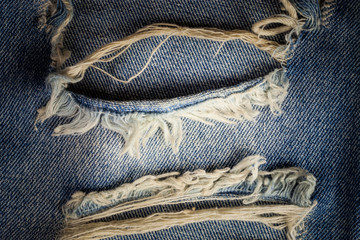 The old blue jeans dirty at torn for background.