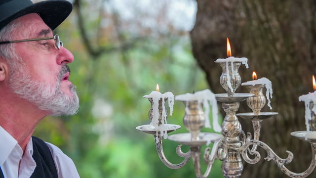Blowing the candles on lampstand