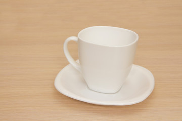 Empty cup on a wooden background