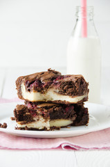 Brownie stuffed with raspberry and cheesecake, with milk, on pin