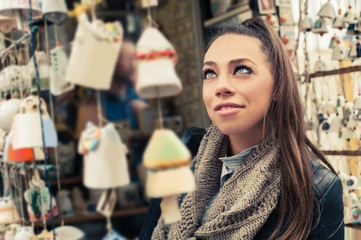 Woman buying souvenirs / Young woman buying souvenirs in gift shop