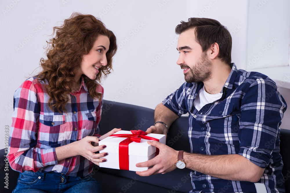 Wall mural young man giving present to his girlfriend