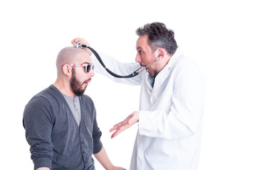 Young patient acting foolish during head examination