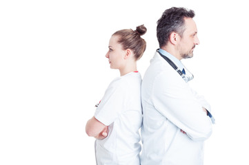 Portrait of two confident doctors standing back to back