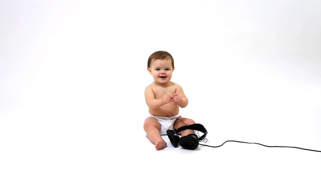 Baby playing with headphones