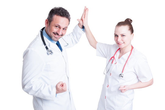 Happy team doctors give high five and celebrate success