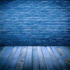 brickwall with wooden table under blue light