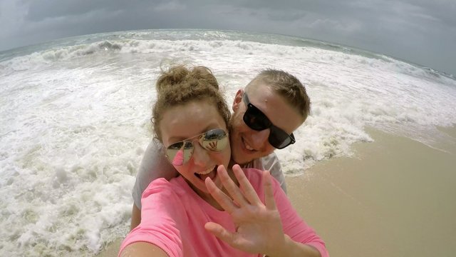 4K. Happy Young Couple Taking Selfie on Beach by the Sea