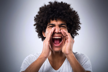 Young man with afro shouting