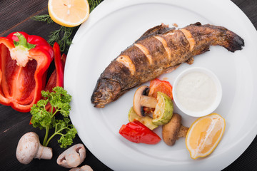 baked fish with lemon and grilled vegetables