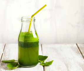Apple and spinach juice in bottle