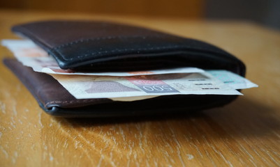 Detail of Czech currency (Czech Crowns, CZK, Kč, Kc) in the leather wallet 